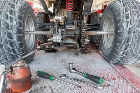 Tools under a ATV being repaired